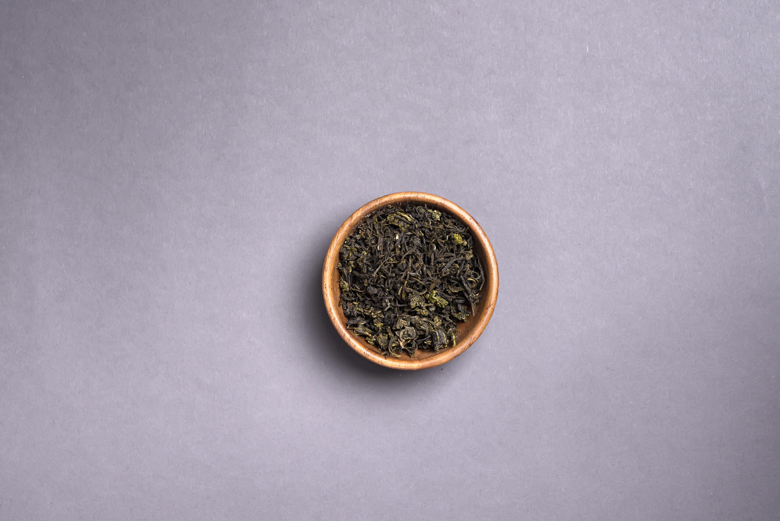 green tea dried leaves on gray background