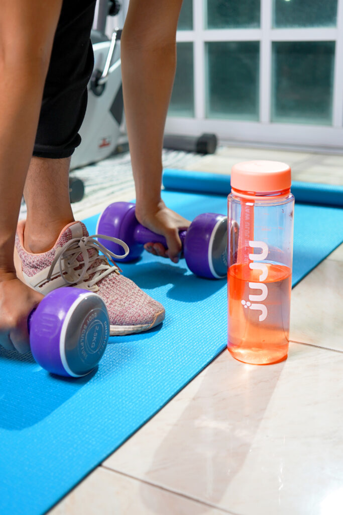 Weights exercise session in the gym with Juju Easyslim water container infront.