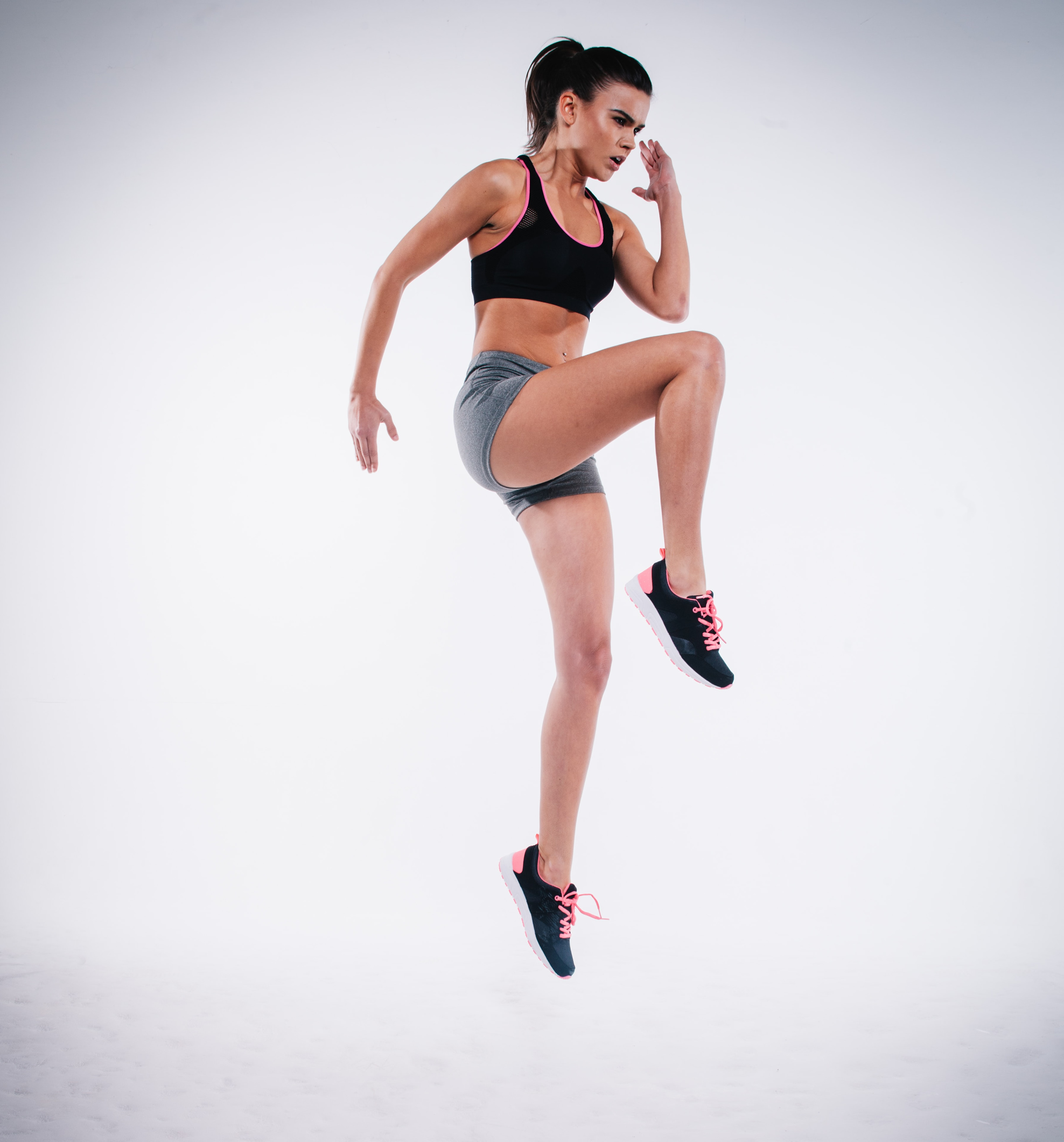 A fit woman doing power skip exercise.
