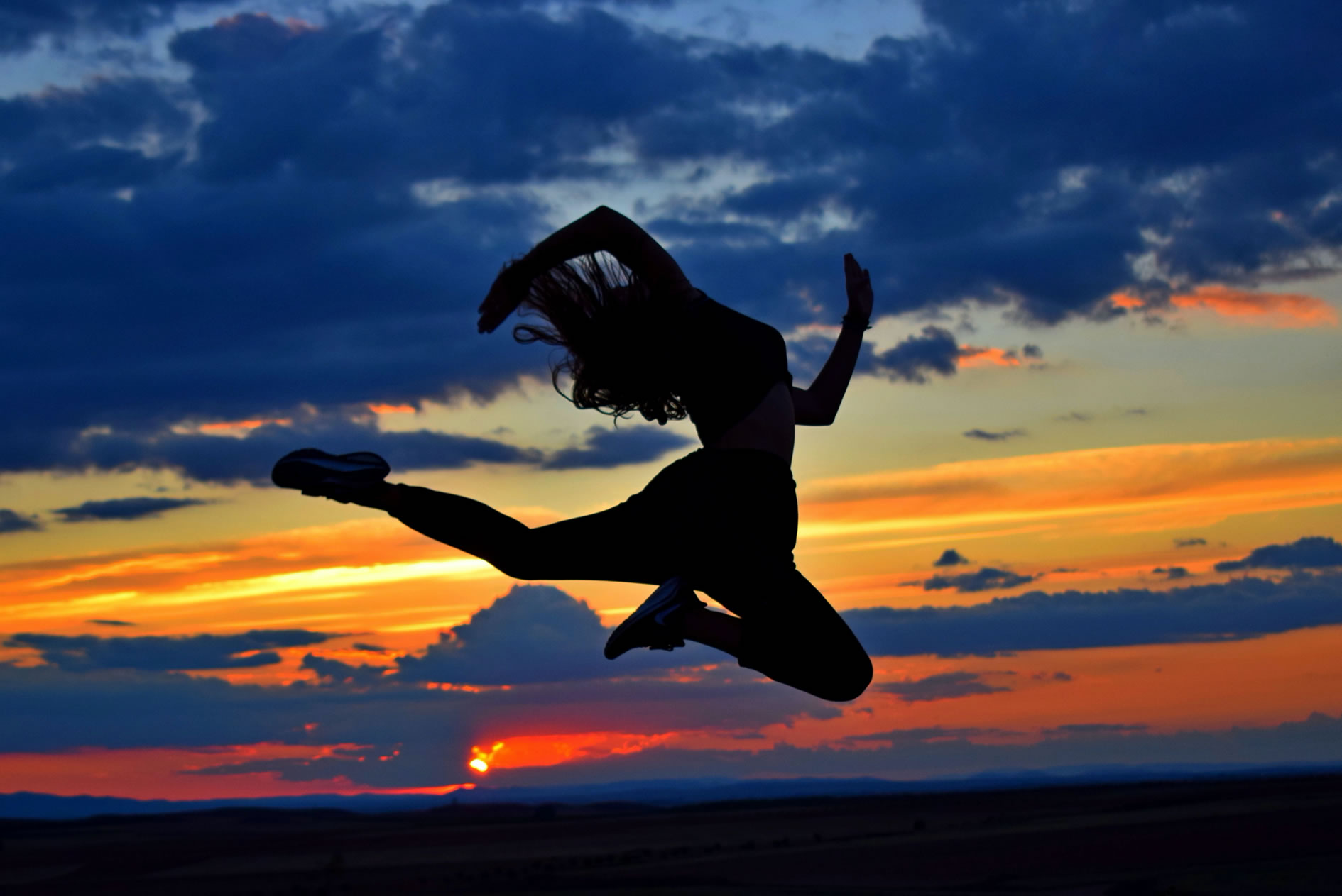 Woman doing leap exercise outdoors