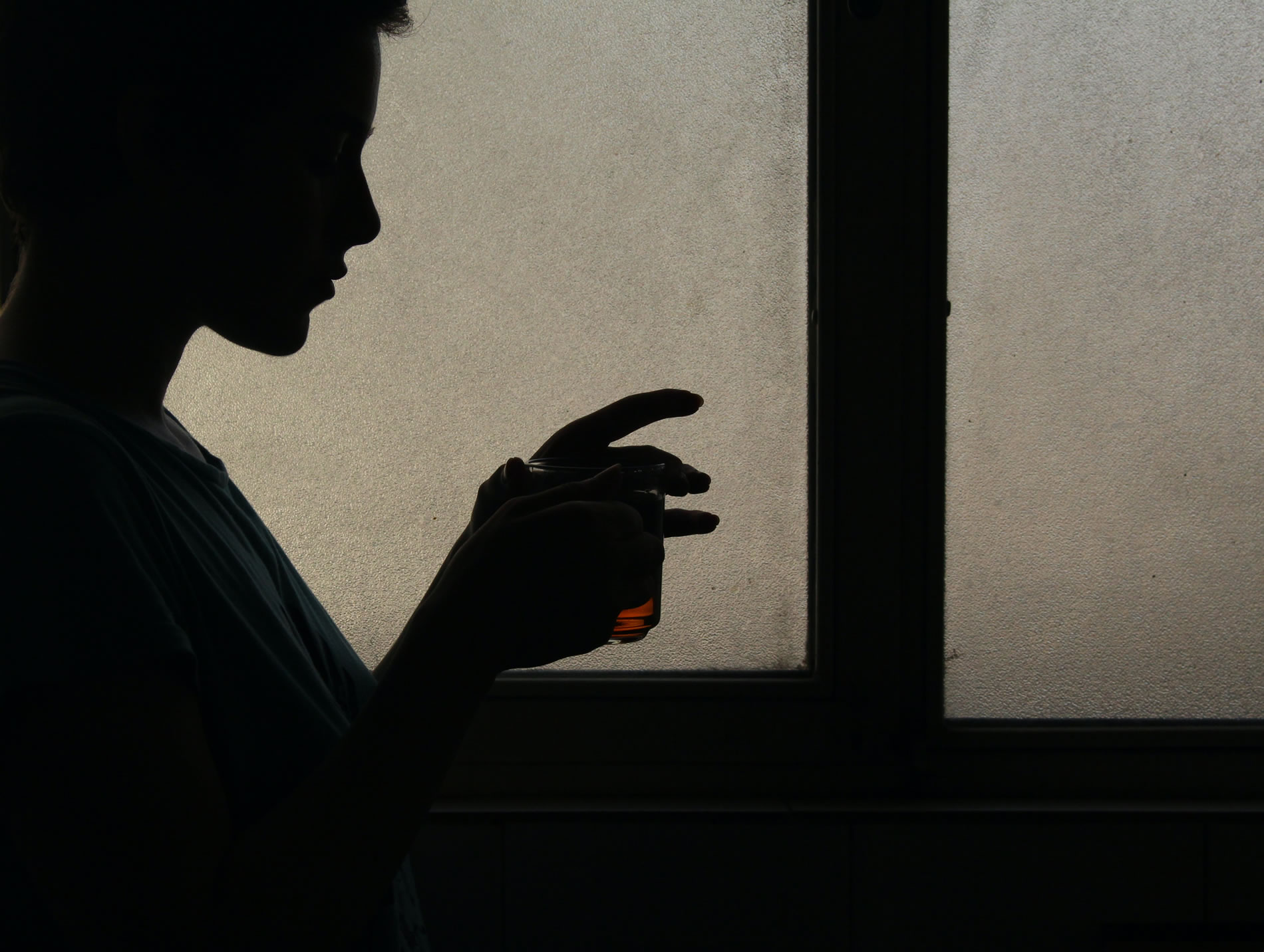 Woman drinking collagen beauty drink in dark background