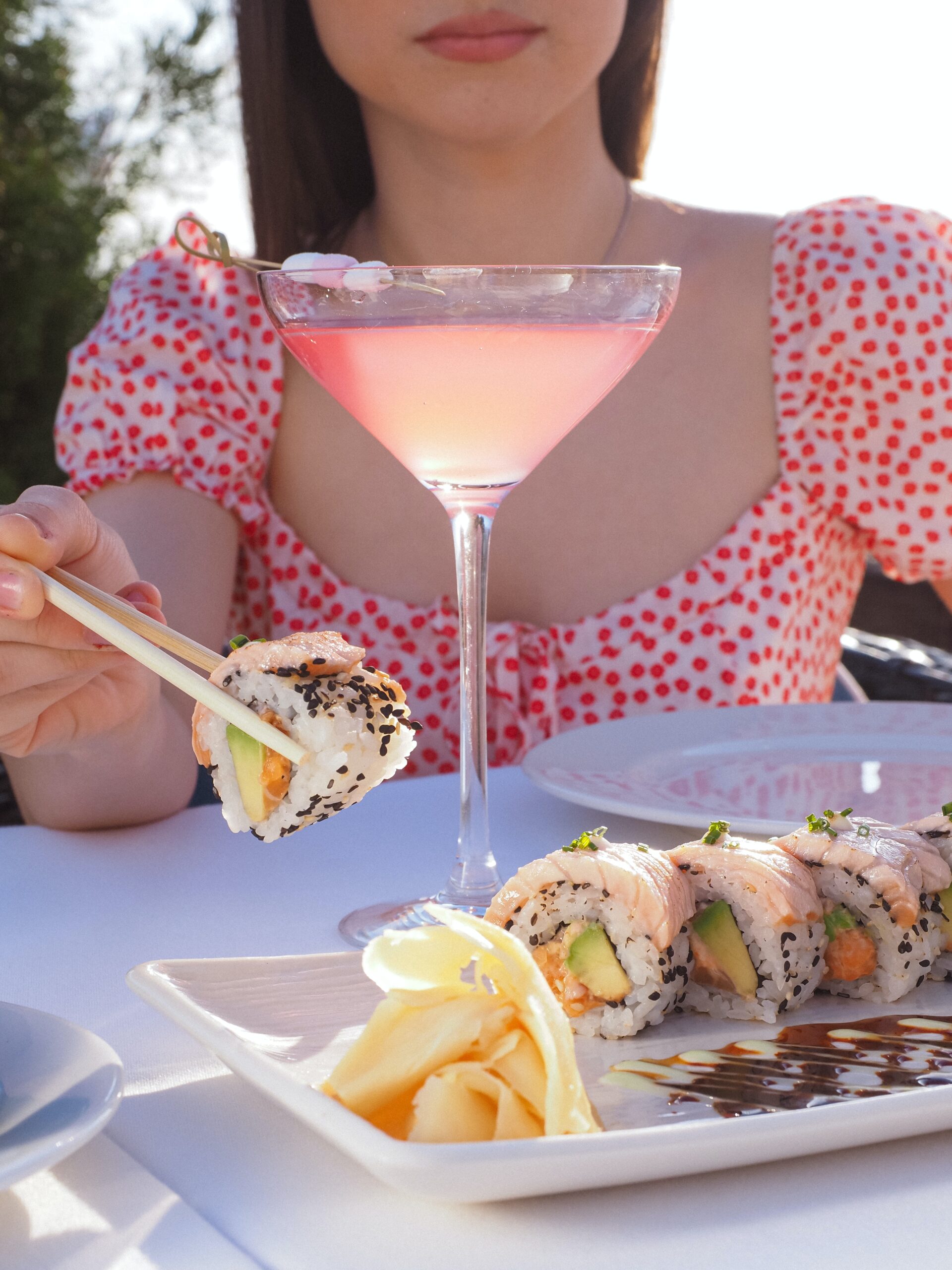 Woman eating sushi and with collagen drink in her glass. This is for the post fish collagen benefits.