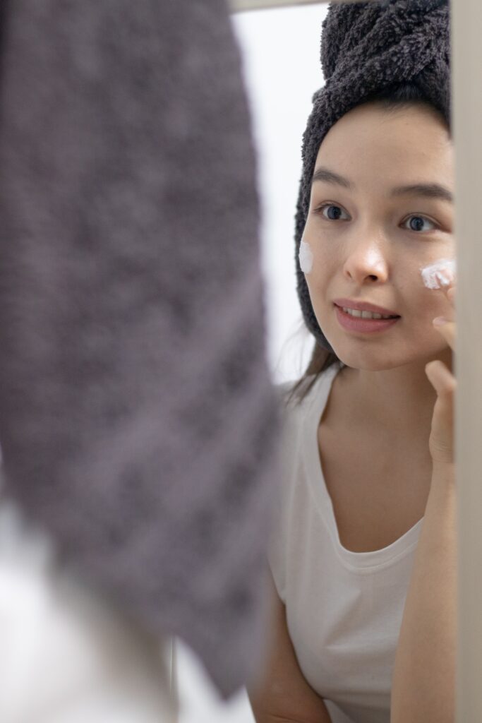 Woman applying face moisturizer for the post Benefits Of Moisturizing Face